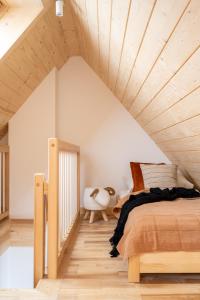 a bedroom with a bed and a wooden ceiling at Domek Aziza in Kościelisko