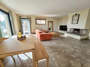 a living room with a couch and a fireplace at Belle villa avec piscine et vue mer- Hauteurs de Bastia in Bastia