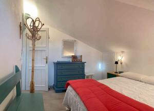 a bedroom with a bed and a blue dresser at Sardegna Beach Ginepro in Olbia