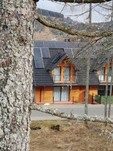 a house with solar panels on top of it at Domek Aziza in Kościelisko