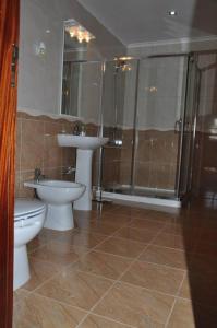 ein Badezimmer mit zwei Toiletten und einem Waschbecken und einer Dusche in der Unterkunft Casa da Mineira T1 in Geres