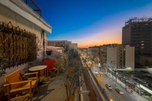 a view of a city street at sunset at Chic 2BR Bright Penthouse with Open Wood Staircase in Athens