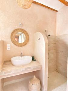 a bathroom with a sink and a mirror at Kaouki Lodge in Sidi Kaouki