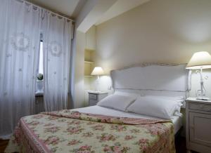 - une chambre avec un grand lit et une fenêtre dans l'établissement Emily Luxury Apartment, à Vérone