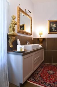 La salle de bains est pourvue d'un lavabo et d'un miroir. dans l'établissement Emily Luxury Apartment, à Vérone
