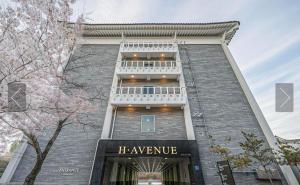 a large brick building with a sign that reads he avenue at H Avenue Gyeongju Bulkuk temple in Gyeongju