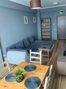 a living room with a table and a couch at The View Apartment in Constanţa