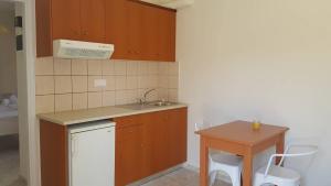 a small kitchen with a sink and a table at Mear Holiday Homes - Cretan Summer Getaways in Kountoura Selino