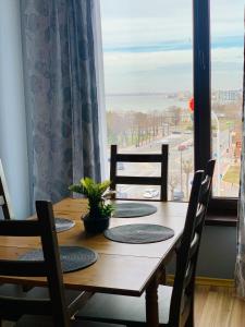 a dining room table with a view of the ocean at The View Apartment in Constanţa