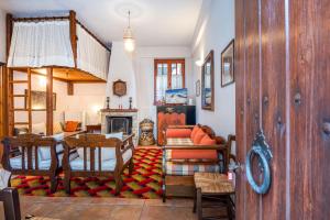 a living room with a table and a couch at Nelfi's apartments I - Αράχωβα in Arachova