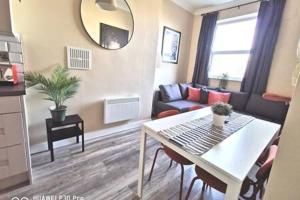 a living room with a table and a couch at Cosy Apartment near OConnell ST RELIABLE FAST WIFI in Dublin