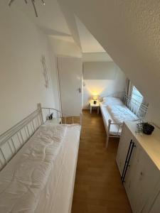 two beds in a room with a attic at Beach Club Fehmarn 9249 in Fehmarn
