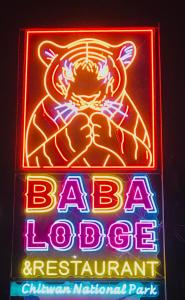 a neon sign for a baja restaurant with a crab on it at BABA lodge & restaurant in Sauraha