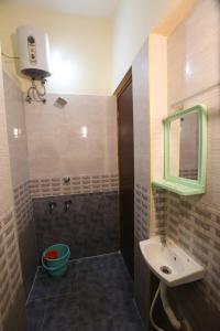 a bathroom with a sink and a mirror at ABOORVA GRAND INN _ HOMESTAY_ ROOMS _RESORT _HOTEL IN KUMBAKONAM in Kumbakonam