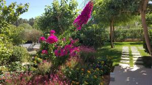 a garden with pink flowers in a park at Mear Holiday Homes - Cretan Summer Getaways in Kountoura Selino