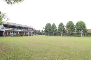 a large grass field in front of a building at Grand Nirwana Resort Lembang in Tangkubanperahu