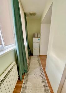 an empty room with a radiator and a window at 2х комнатная квартира на Айтиева in Taraz