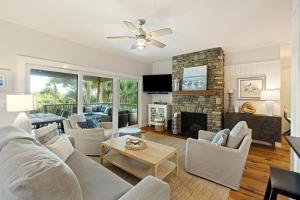 a living room with a couch and a fireplace at SS3510: 3510 Seascape in Kiawah Island