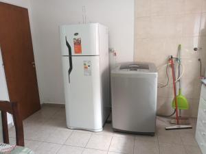 a white refrigerator and a trash can in a kitchen at Lo de fernando 3 in Río Gallegos