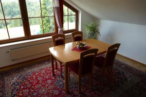 a dining room with a wooden table and chairs at Bushof - Leben auf dem Land in Sulzbach an der Murr