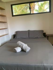 een knuffeldier zit op een bed bij Villa Malinao Oceanview Resort- Superior Bungalow in Burgos