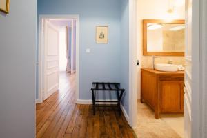 a bathroom with a sink and a mirror at Grand Hôtel de l'Europe - Morlaix Centre in Morlaix +125 photos