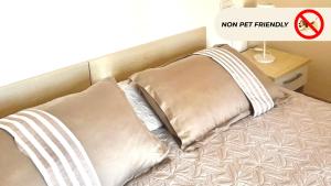 a bed with two pillows and a sign that says new pt therapy at Casa in Maremma Tuscany Village in Scarlino