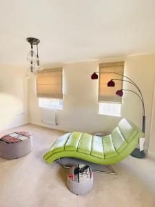 a living room with a green couch and a lamp at Cozy and comfy in Stanion