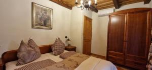 a bedroom with a bed with pillows on it at Kasza Rusztika in Szekszárd
