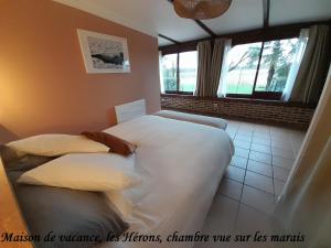 a bedroom with two beds and a window at Domaine de l'Ermitage in Rue