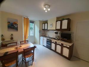 a kitchen with a table and a dining room at Appartement T2 eaux-bonnes in Eaux-Bonnes