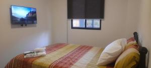 a bedroom with a bed and a flat screen tv at Hermosa Suit en la Playa in Data de Villamil