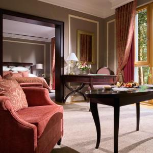 a bedroom with a bed and a table and a chair at Castlemartyr Resort Hotel in Castlemartyr