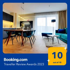 a living room with a table and a couch at Comfort Apartment A102 SEA VIEW 10th floor PARKING FREE in Międzyzdroje