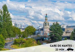 a view of a city with a bridge and a building at Le Joséphine in Nantes