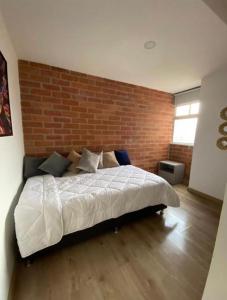 Een bed of bedden in een kamer bij Impecable y lujoso apartamento para una estadía unica