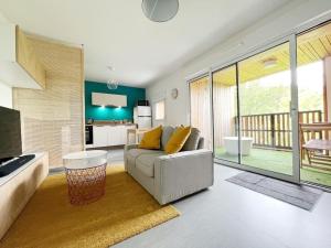 a living room with a couch and a large window at Le Joséphine in Nantes