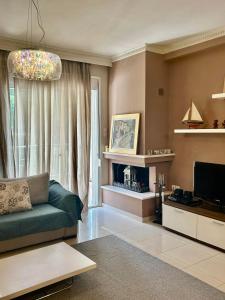 a living room with a couch and a television at CYNTHIA COMFORT LIVING VOLOS in Volos