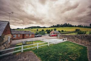 a view of a farm with a car parked in a driveway at Cottages In Derbyshire, Oak Cottage in Hazelwood