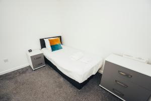 a bedroom with a bed and a dresser at Cottages In Derbyshire, Oak Cottage in Hazelwood