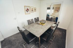 a dining room with a table and chairs at Cottages In Derbyshire, Oak Cottage in Hazelwood