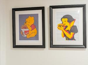 two framed pictures of winnie the pooh eating food at Birmingham Apt-Sleeps 4-Walk to City Centre-Pets in Birmingham