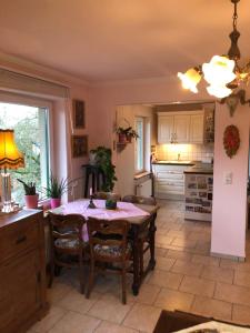 a kitchen with a table and chairs in a room at Little Cottage auf 2 Etagen in Raben Steinfeld