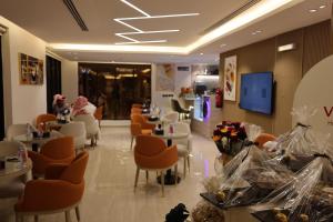 a restaurant with orange chairs and tables and a lobby at فيرانو - Virano in Riyadh