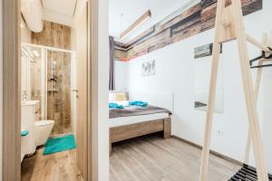 a small bathroom with a bed and a shower at Elemental Retreats - Wood & Water Studios in Budapest