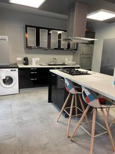 a kitchen with a stove and a sink and a dishwasher at Lumineux Appart à Disneyland in Montry