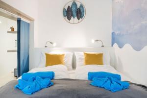 a bedroom with a bed with blue towels on it at Elemental Retreats - Wood & Water Studios in Budapest +37 photos
