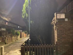 a street with a fence and a sign on a building at Standard Villa in London