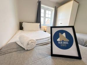 a room with a bed with a sign on it at Coral House by Blue Skies Stays in Thornaby on Tees