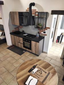a kitchen with a stove and a table at Loft Porta Sud in Brindisi